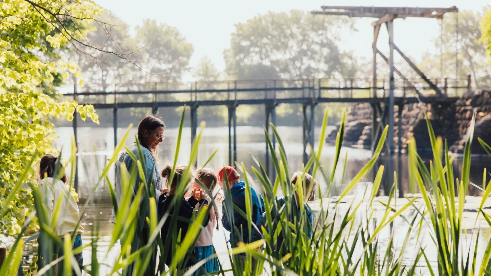 Visitors exploring the scenic nature and castle moat at Soebygaard. A popular historical landmark and cultural experiences visitor hub on Aeroe Island in Denmark.