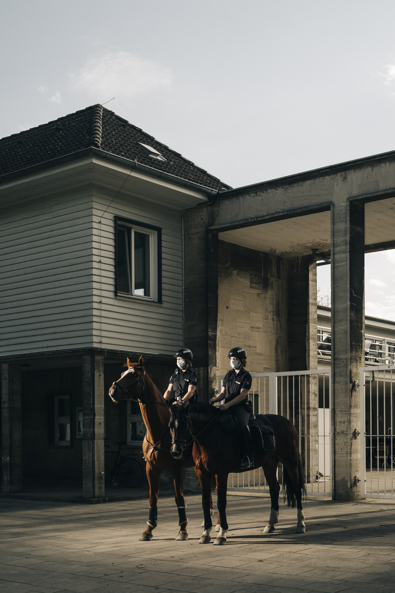  Policewomen of the equestrian squad pose for a portrait during their patrol at the Maschseein Hanover, on the day when masks arecompulsory in Germany. 