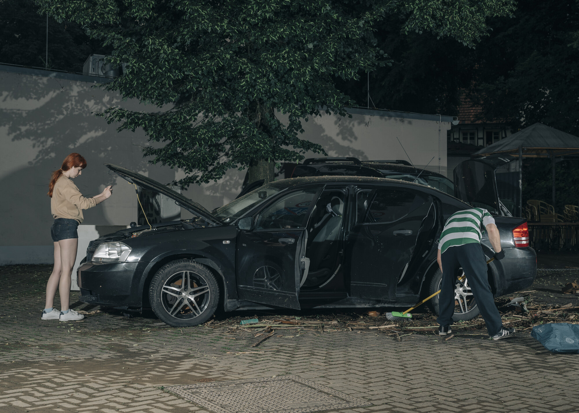  A couple from Hagen inspects their car, which was damaged by the flood. Since they do not have comprehensive insurance, they have to pay for all the damage to their car themselves. 