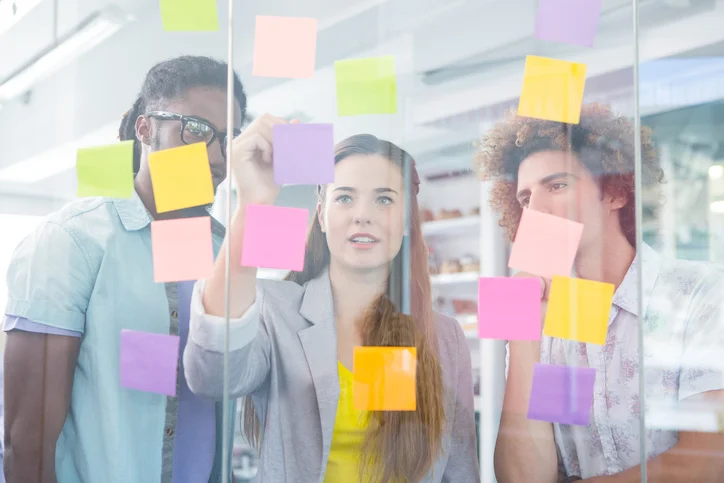 Creative team writing on adhesive notes.jpg