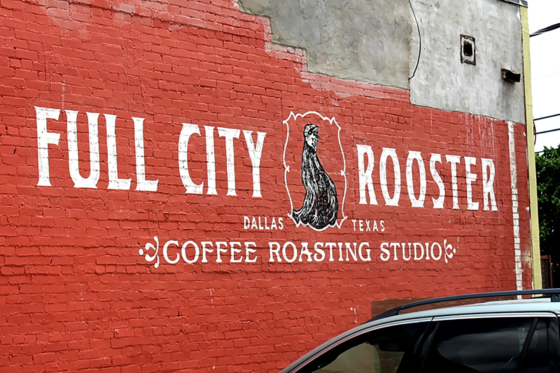 Mural on a red brick wall for Full City Rooster coffee roasting studio in Dallas, Texas, featuring a stylized rooster illustration.