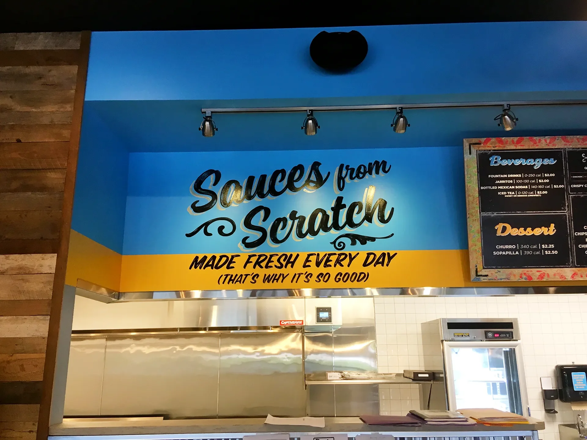 Sign in a restaurant reads 'Sources from Scratch, Made Fresh Every Day, That's Why It's So Good'.