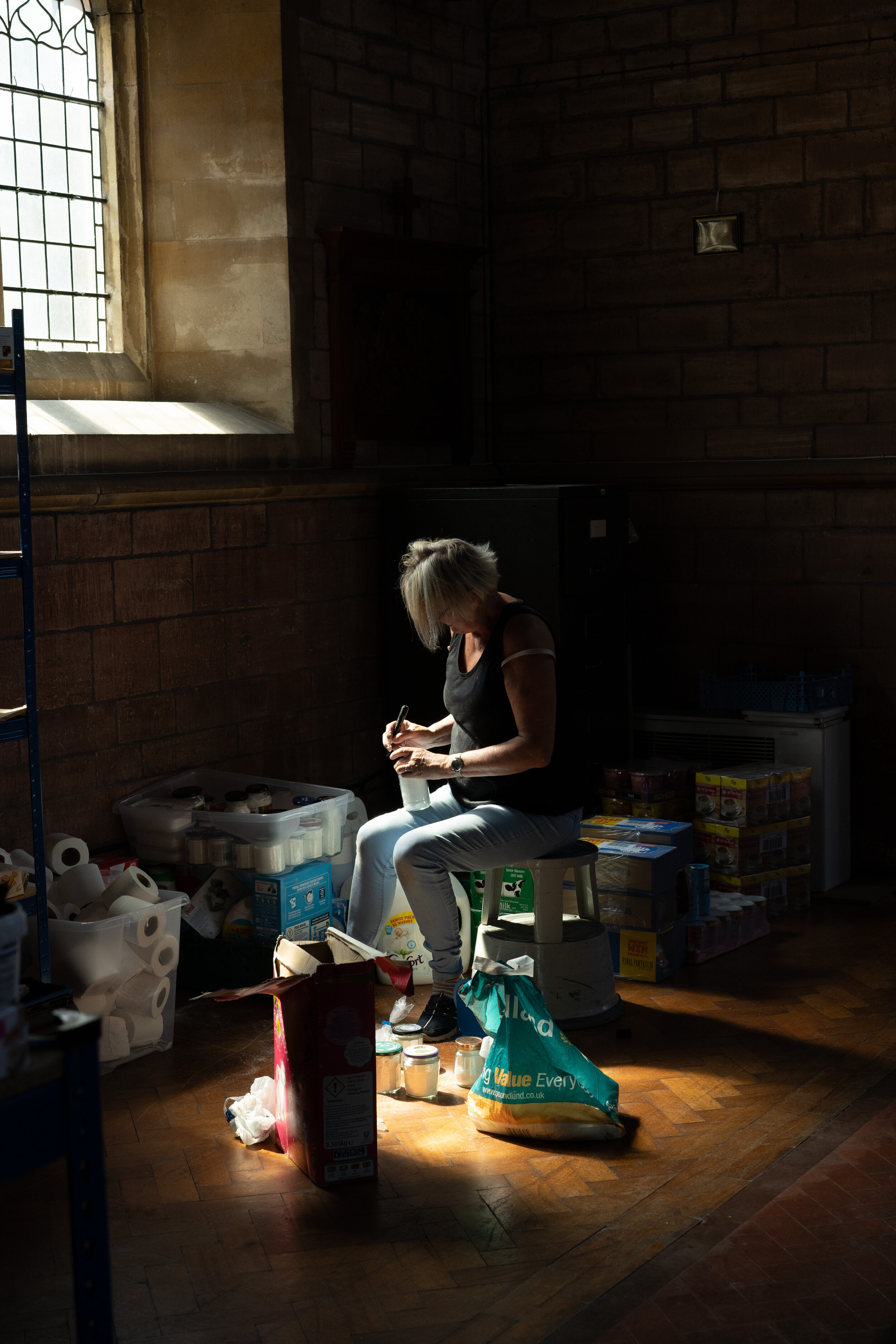 A volunteer divides sanitary items and food into bags, the basics for one person to live from over three days. 