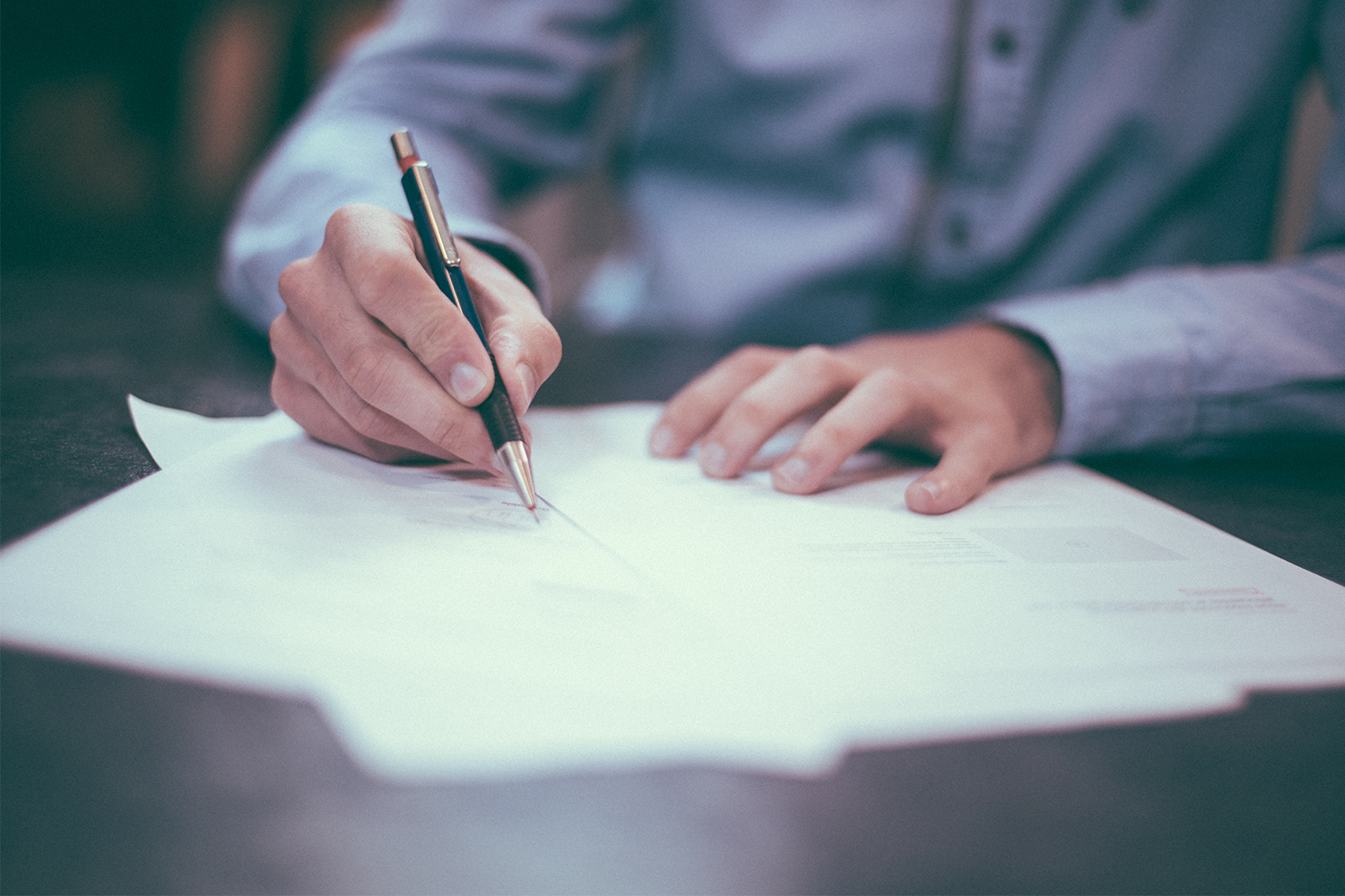 Chris Reid Law - Man Signing A Contract.png