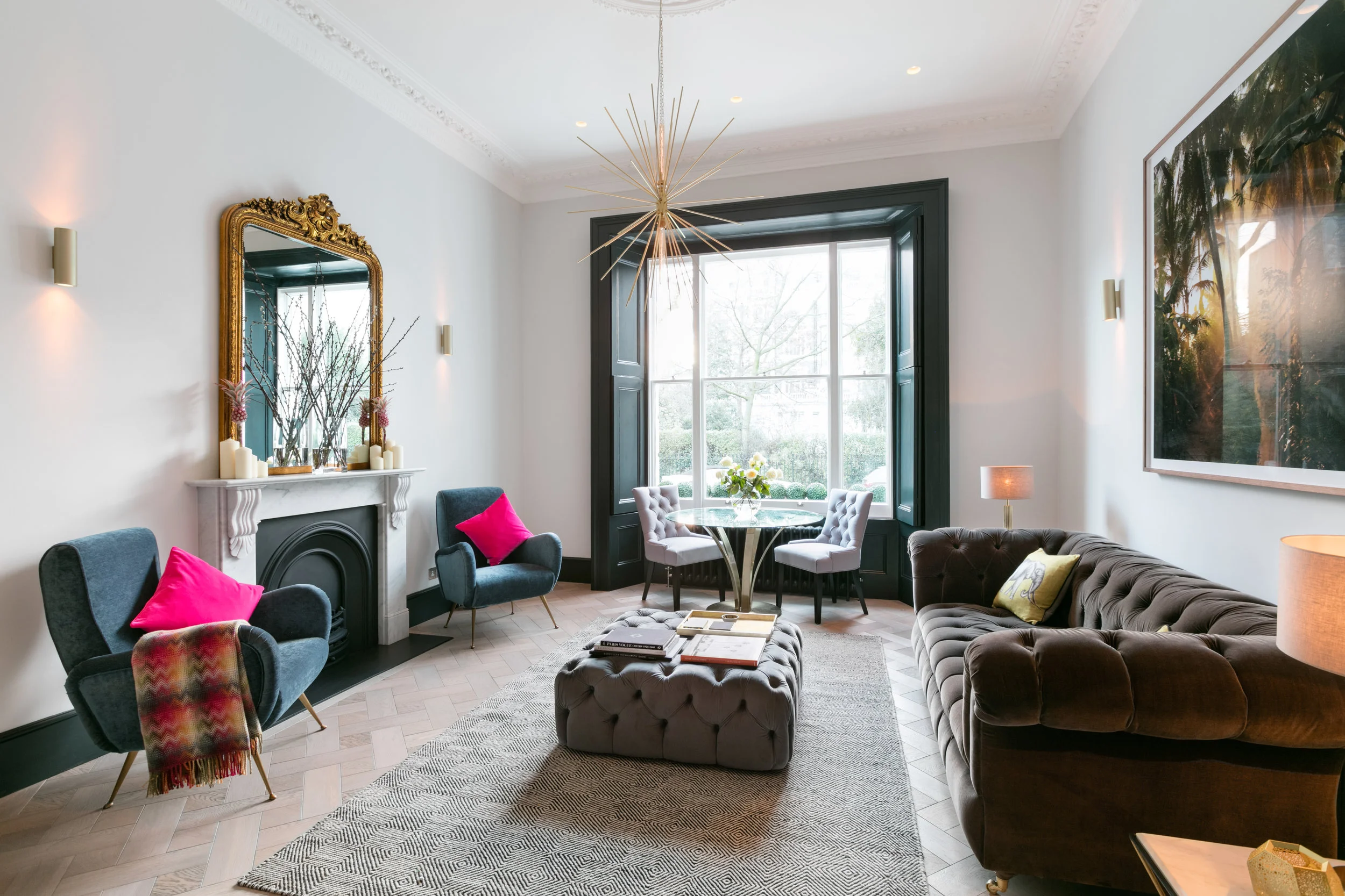 Onslow gardens was a great first project, a small two bedroom property situated on a pretty garden square. The internal works where fairly basic, we removed a wall and ceiling to open up the kitchen and create a open plan living area. The brief was to create a home for young professionals that would be working long hours and would be eating out regularly or perhaps as a pied-à-terre for a family down sizing. We wanted to reference the character of the building with its beautiful high ceilings and intricate cornicing but also add a modern fresh feel to the home. The all black kitchen was designed to look like a piece of furniture like a bar or drinks cabinet and less like a kitchen. Although the kitchen is small and compact we were still able to install a full size fridge freezer, dishwasher, oven, microwave,hob and lots of storage to make this a fully functional and practical kitchen space. The best original feature of the property was the large west facing sash window. To highlight this feature I took the decision to paint the frame in Farrow and Ball 'Black blue ' which frames the beautiful view and has the effect of drawing your eye immediately to the window. I feel this is a well balanced space with maximum use of the relatively small living area, by keeping the space as open as possible and not cluttered with furniture the we have kept this room feeling grand and opulent but still incorporating kitchen, dining and living areas. 