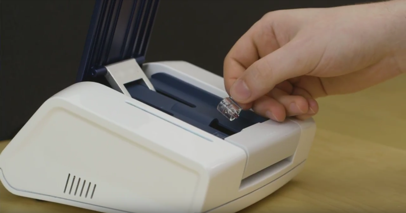  User places the consumable into the rHEALTH X1 blood analysis unit 