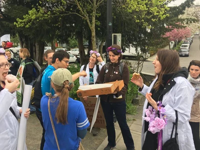 Laura passing out donuts before the Science March in Seattle to members of 500 Women Scientists Seattle and UAW 4121