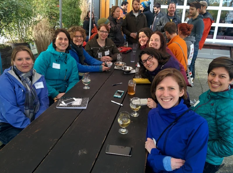 500 Women Scientists Seattle gathered around for a social.