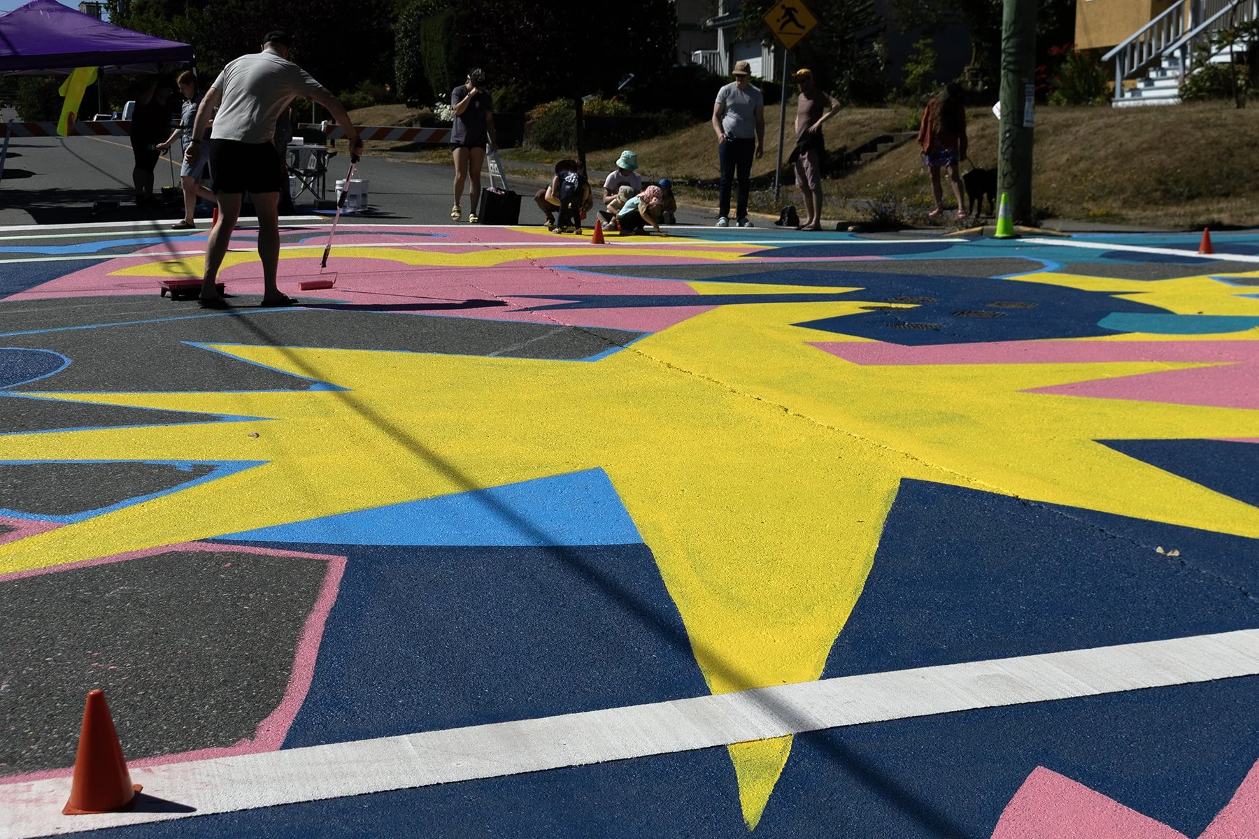 Neighours work on the mural together