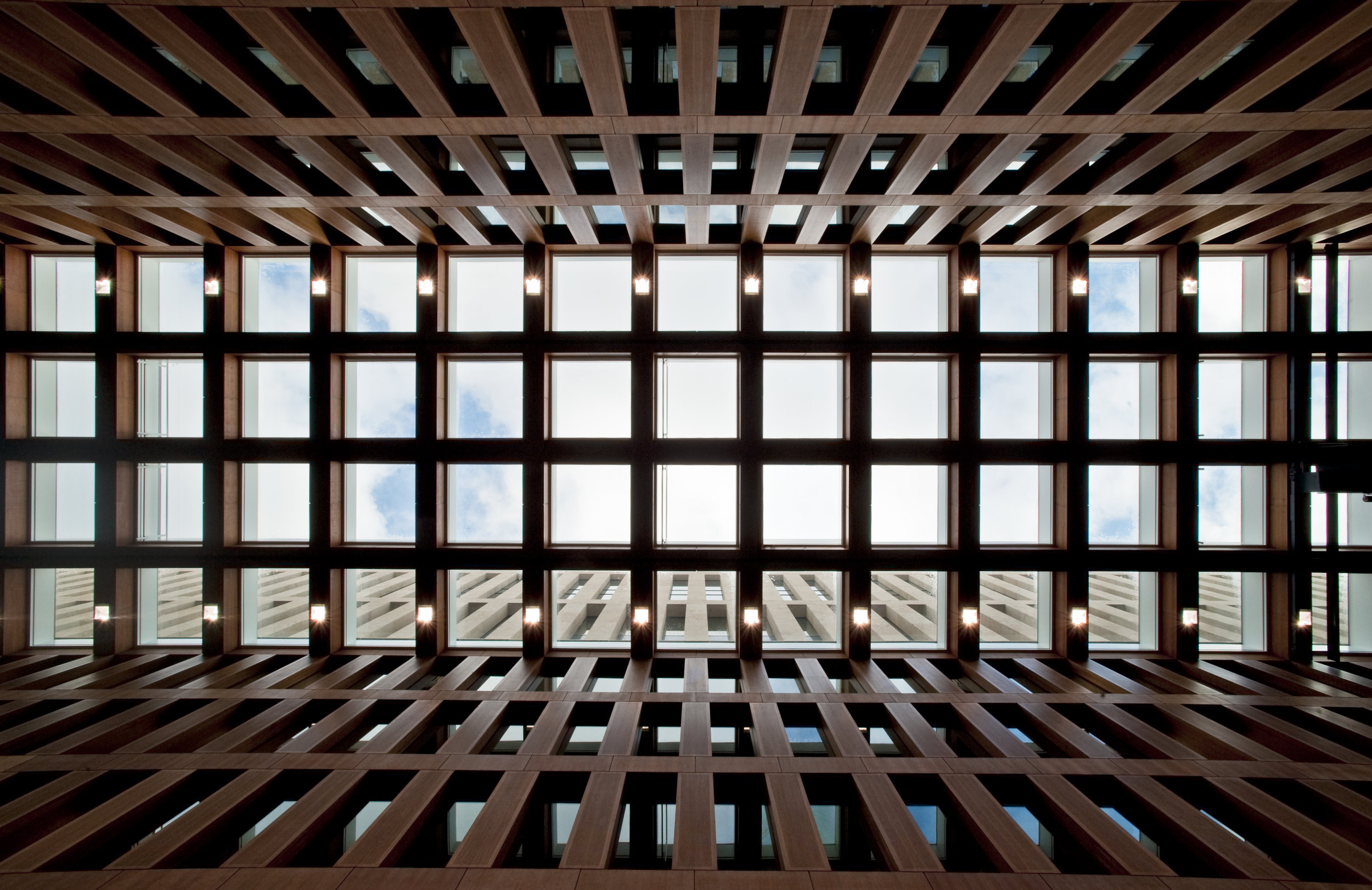 Glass roof systems provide daylight access to offices facing interior courtyard.