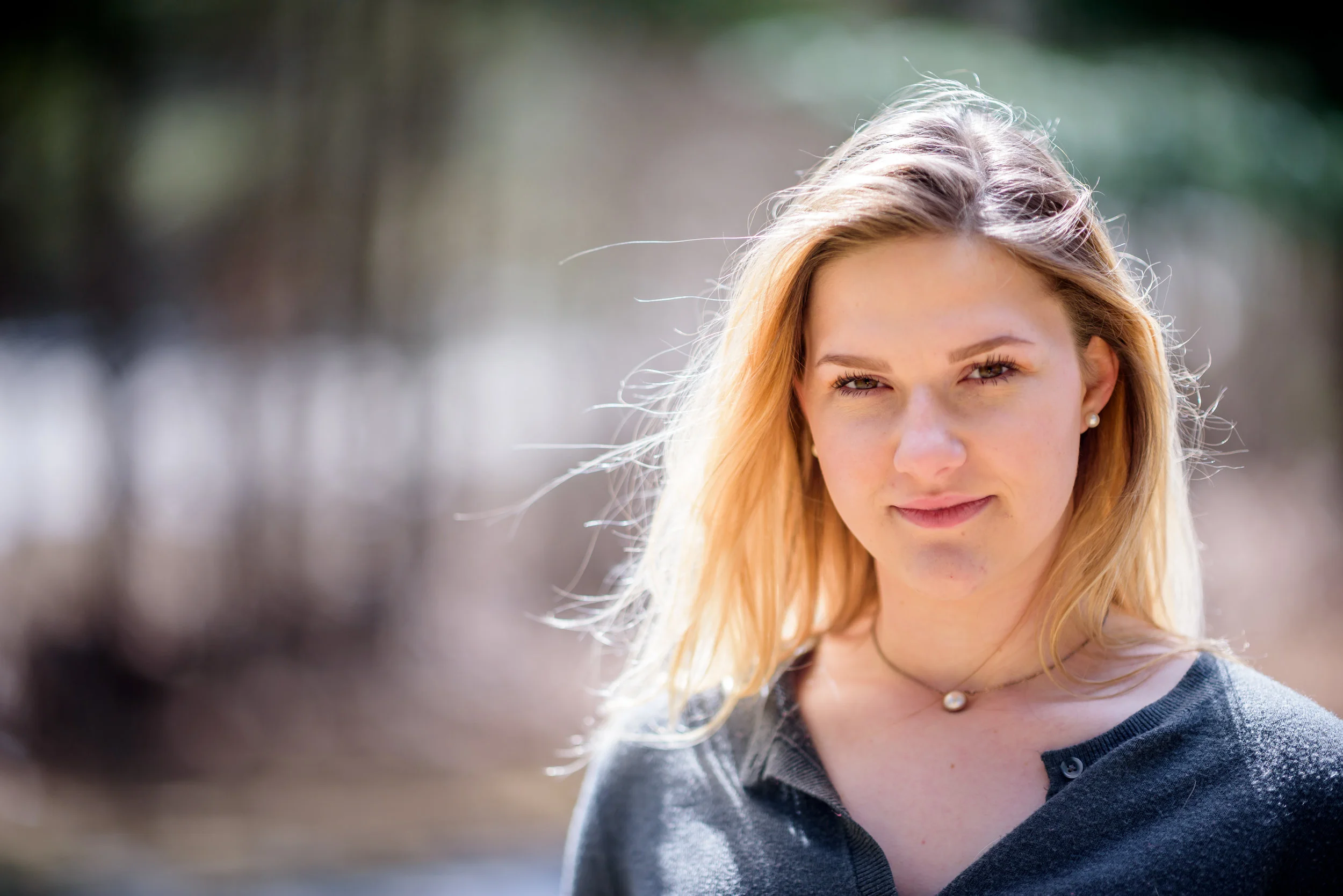 Blonde young woman looking straight at camera