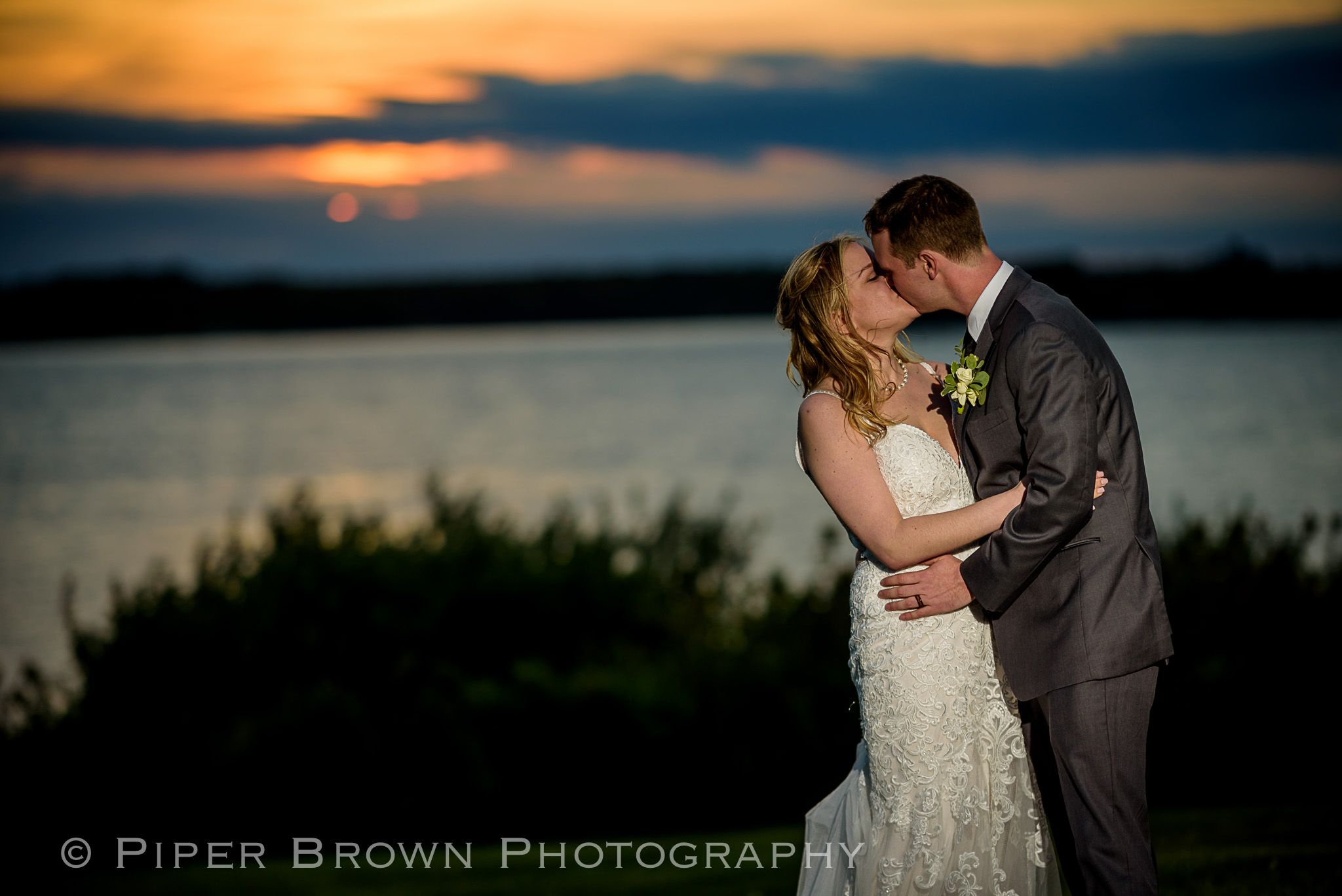 Bride and Groom kissing at sunset in Newport