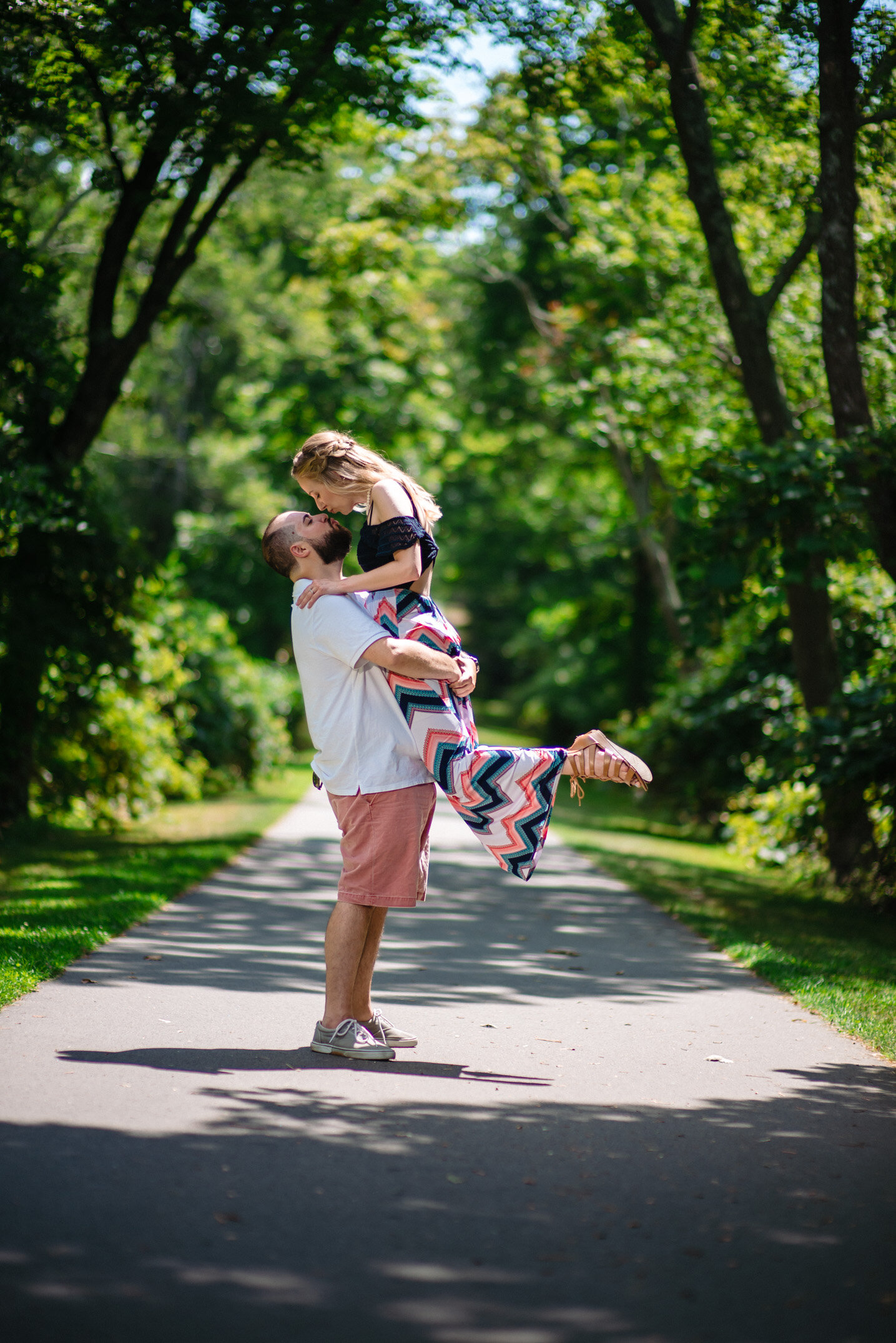 Couple kissing on a path at Colt State Park