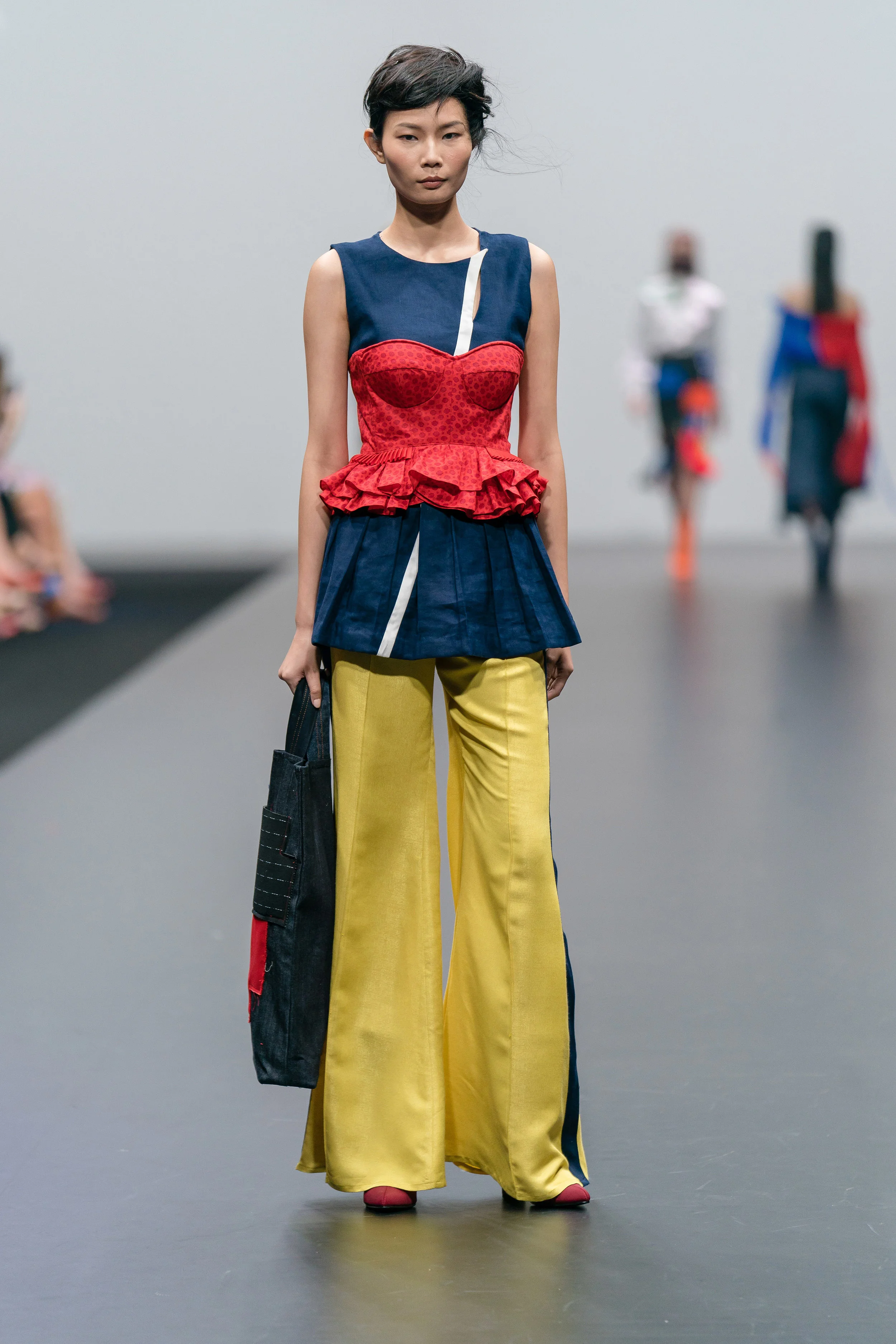 Lina Mayorga Navy peplum and red corset with tailored yellow trousers up-cycled and reconstructed from end-of-rolls, damaged textiles and clothing samples