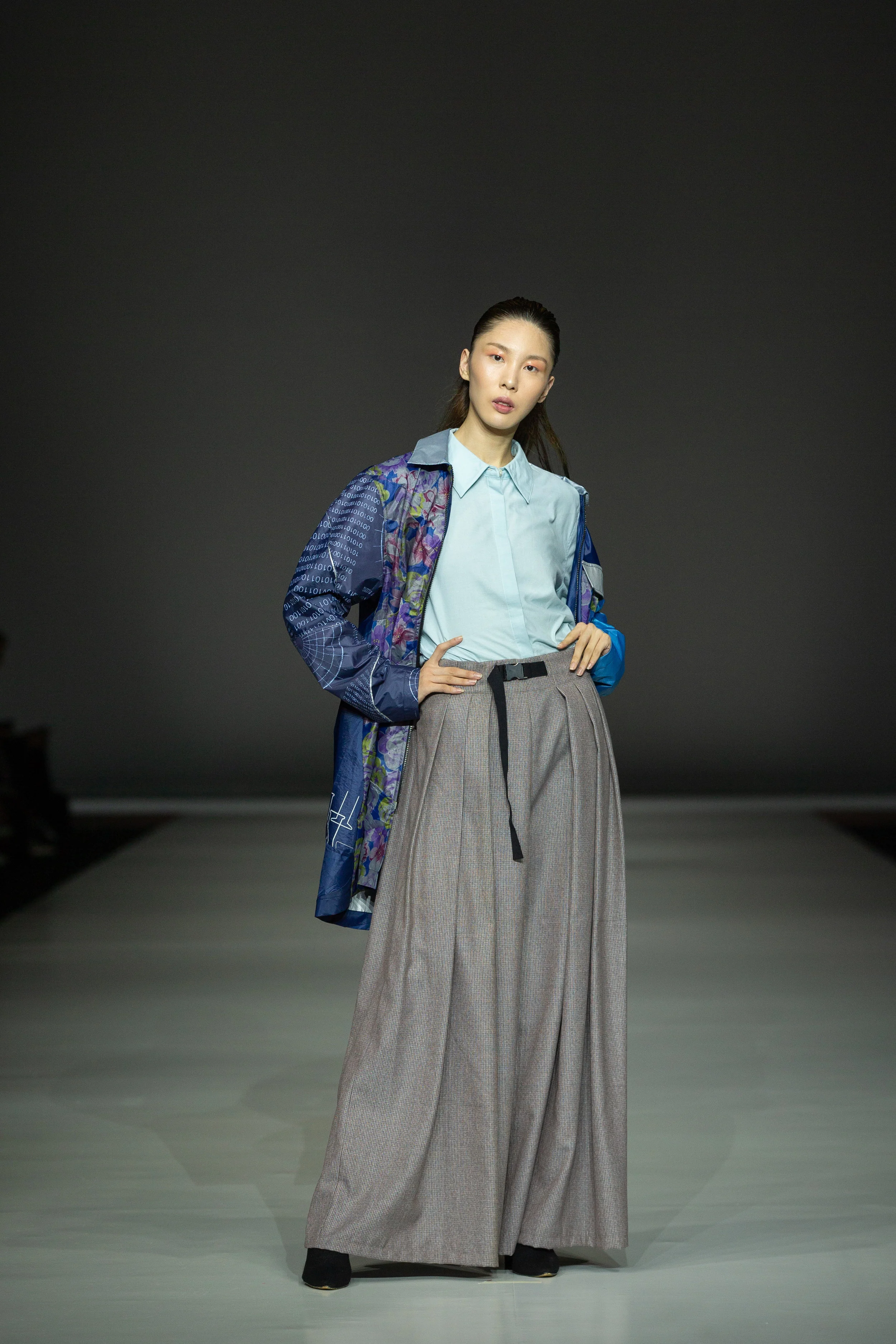 Jesse Lee Oversized cotton dress shirt up-cycled from bedsheets and wide-leg trousers up-cycled from vintage wool, layered with raincoat up-cycled from damaged umbrellas