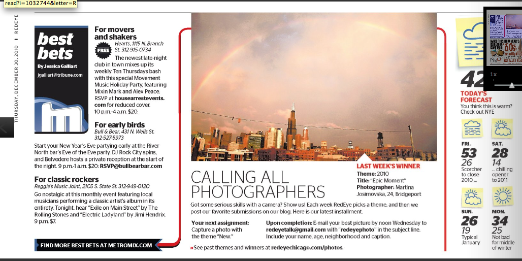 A city skyline with tall buildings under a cloudy sky, with strings of lights hanging across the scene.