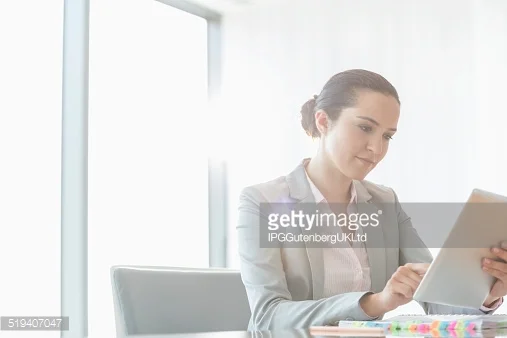 http://www.gettyimages.com/detail/photo/businesswoman-holding-digital-tablet-royalty-free-image/465892541