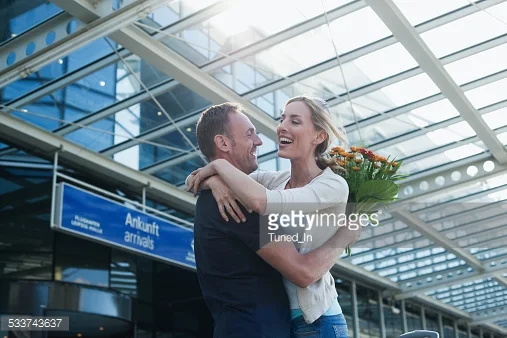 http://www.gettyimages.com/detail/photo/couple-embracing-at-airport-high-res-stock-photography/529578304
