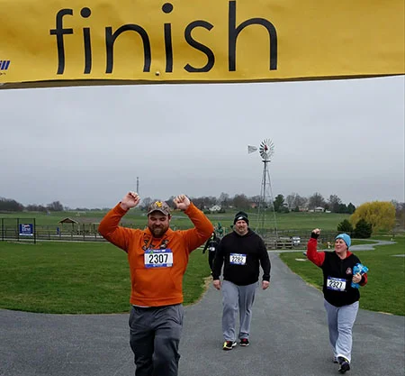 Tom Kershner, Jeff Bert and Dee Rider are happy to cross the finish line.