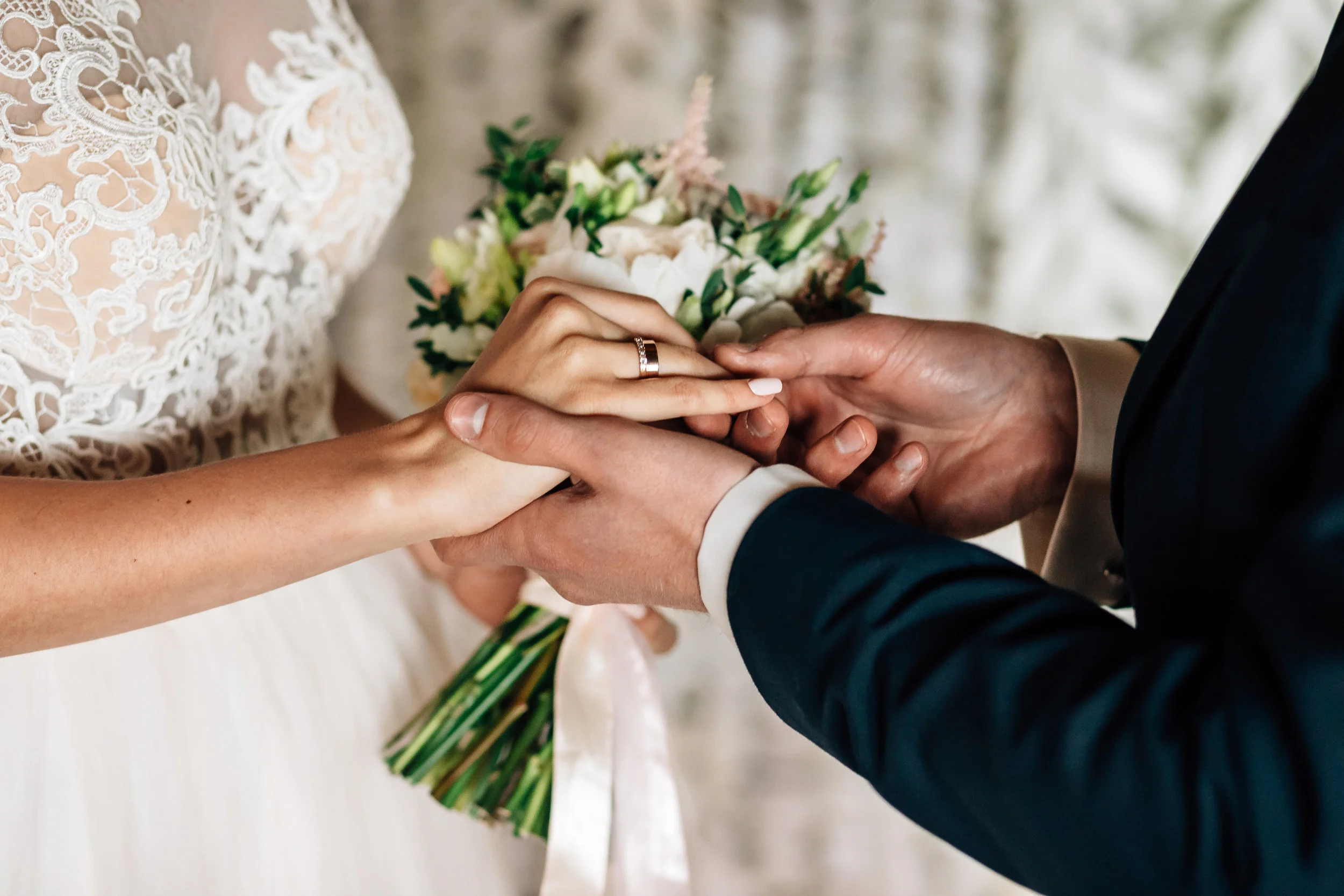 Wedding Hands rings flowers.jpeg