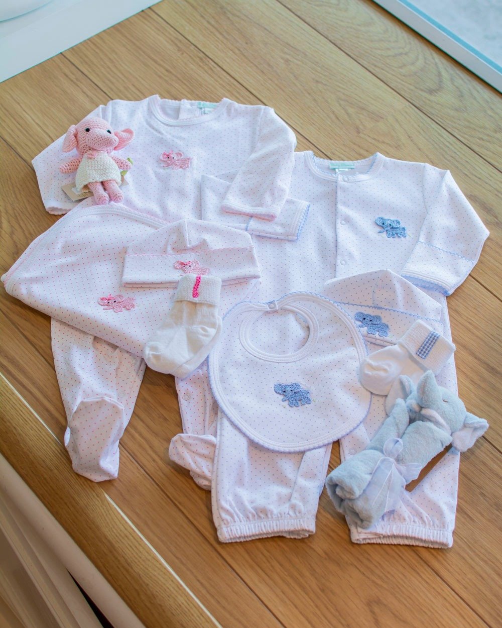 Swipe through to see several boy / girl baby bundles this Spring! Fancy Pants offers free gift wrapping over $10 and we love to help you curate a memorable and special gift.

🐘 From Baby Threads: pink and blue elephants adorn a dotted background. We