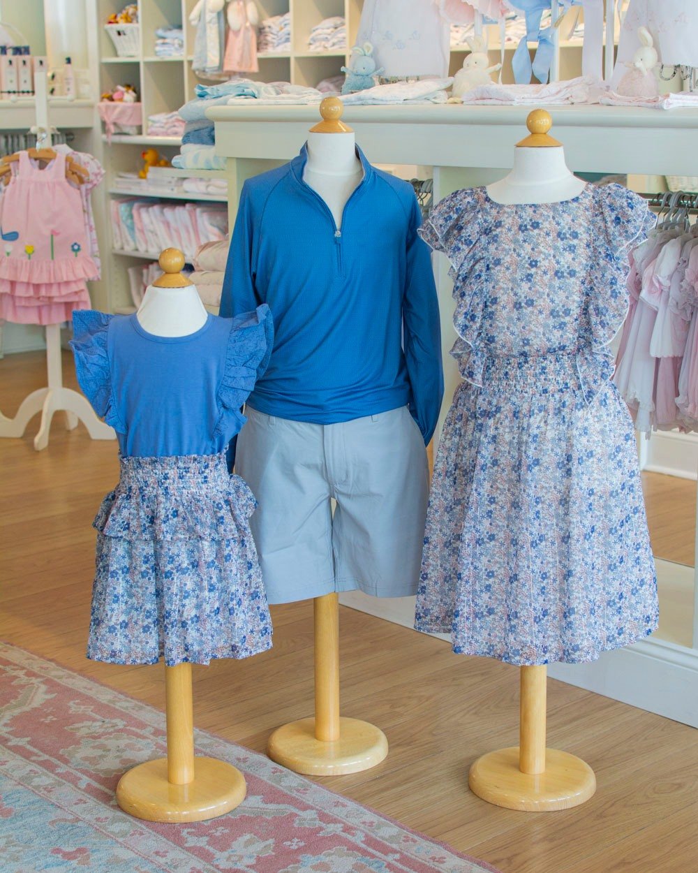 Just in from Creamie! Blue floral print in a ruffle dress and rouched ruffle skirt. We paired it with johnnie-O shorts and a cerulean blue quarter zip.