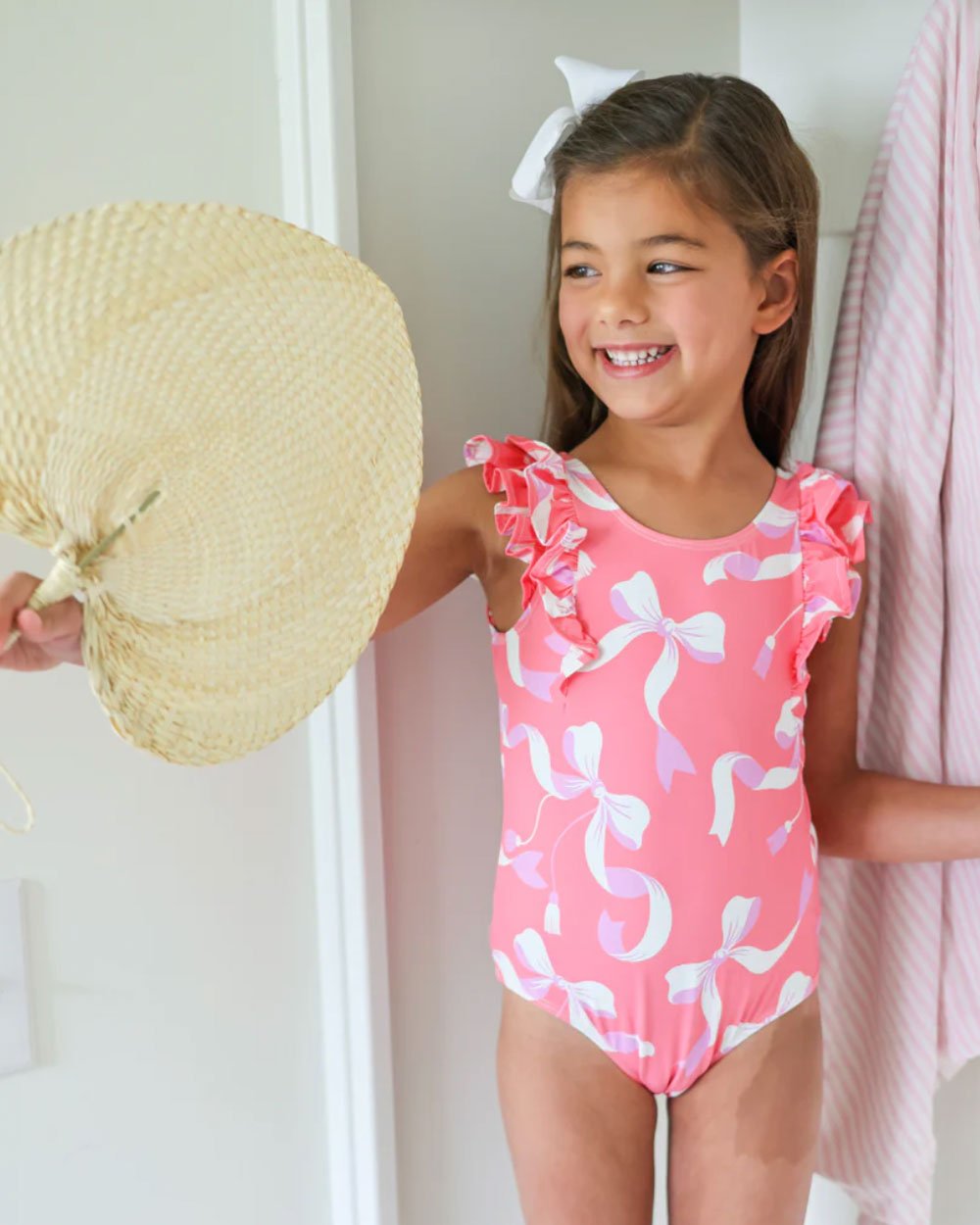 Ruehling Ruffle Bathing Suit in Bagley Bows for girls! 🎀 Tanner Trunks in a gorgeous lavender with blue striped swim shirts from The Beaufort Bonnet.