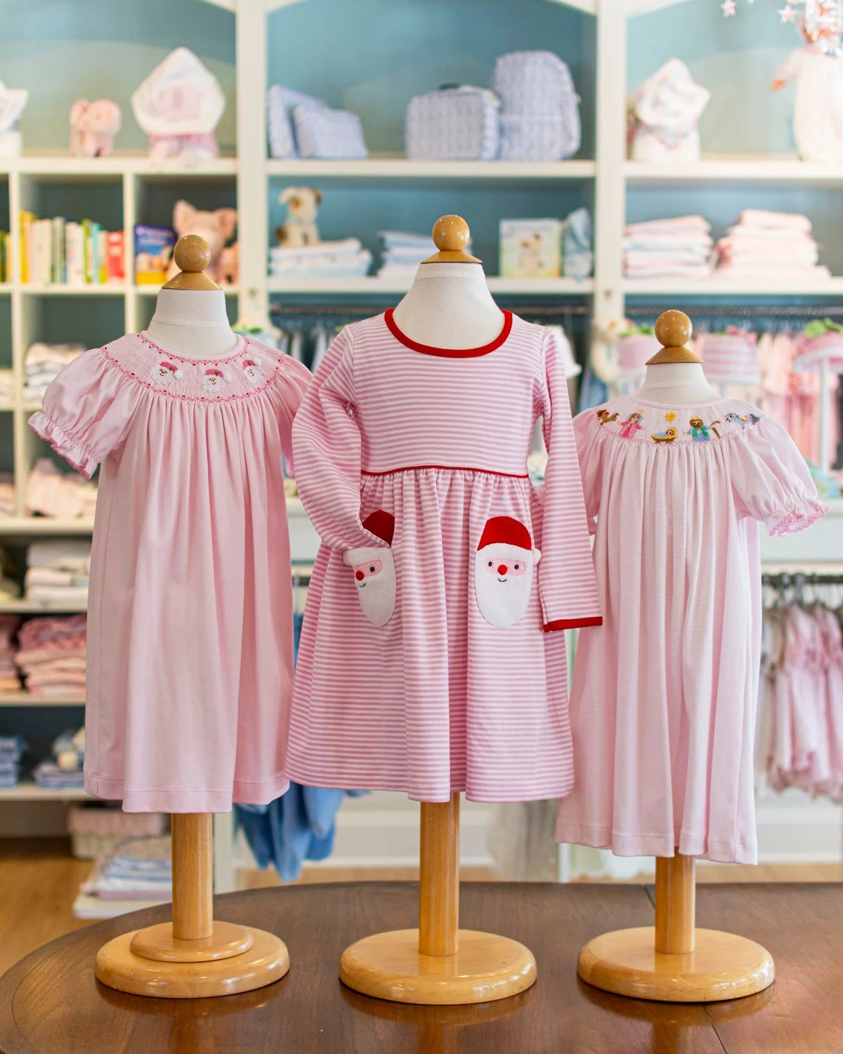 The &quot;Santa Pocket&quot; dress is one we do every year from Squiggles, this year we have it in pink, red and white.🎅 Also smocked pink Christmas styles from Petite Bebe.
