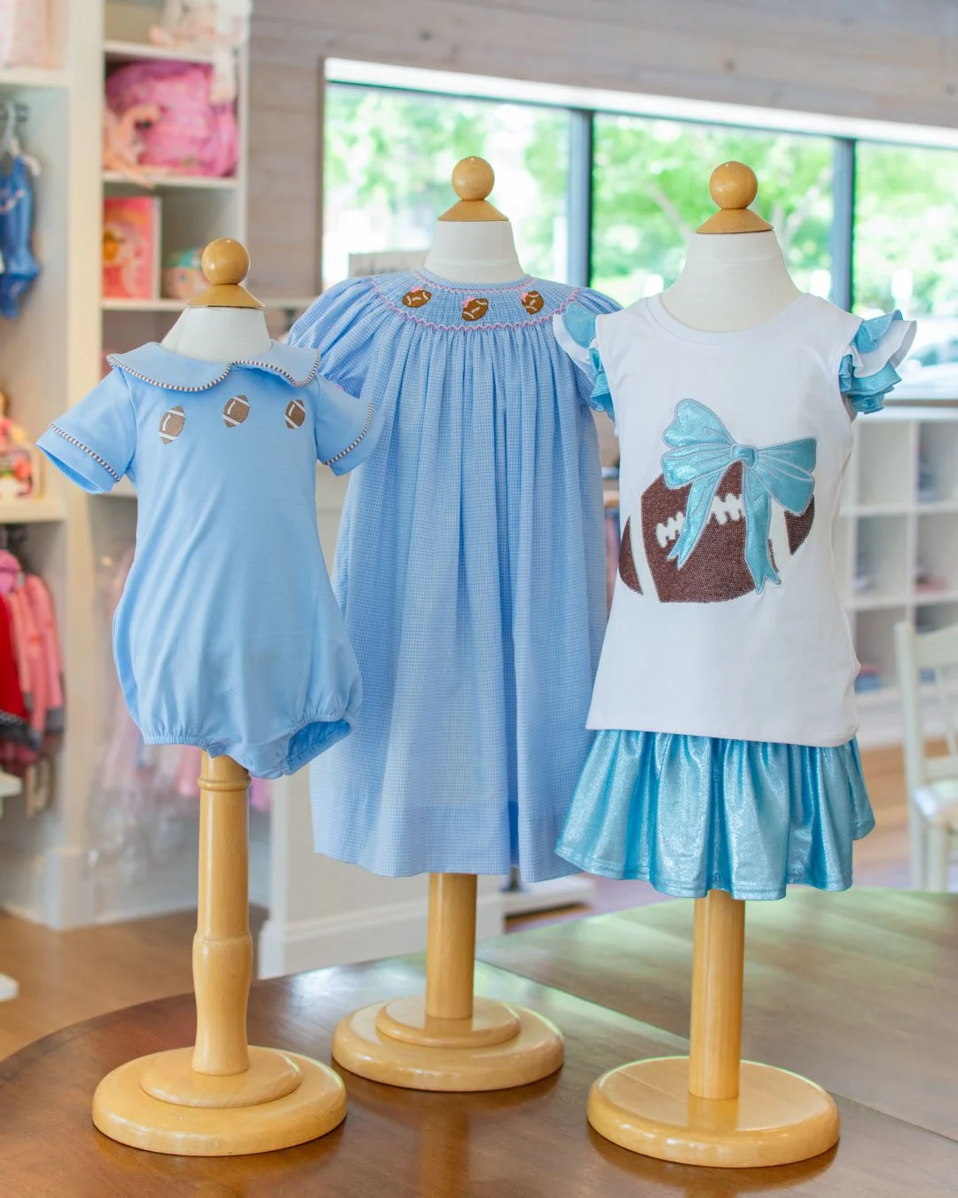 Azarhia football shirts and skorts are just the right blend of girly and sporty. We also adore the pink bows on this smocked dress from Petit Bebe and the bubble from The Bailey Boys. 🏈🏈🏈