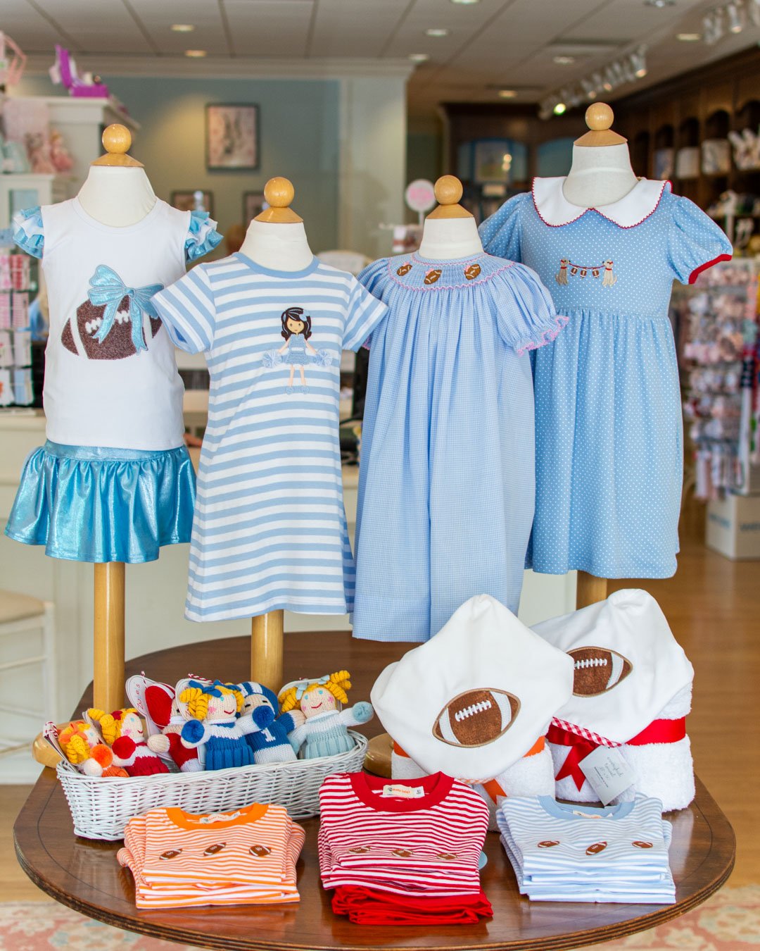 More football wear around the shop for the 2026 Football Season. We love the pups holding the football banner, and these towels make a great gift to a sports family. 🏈