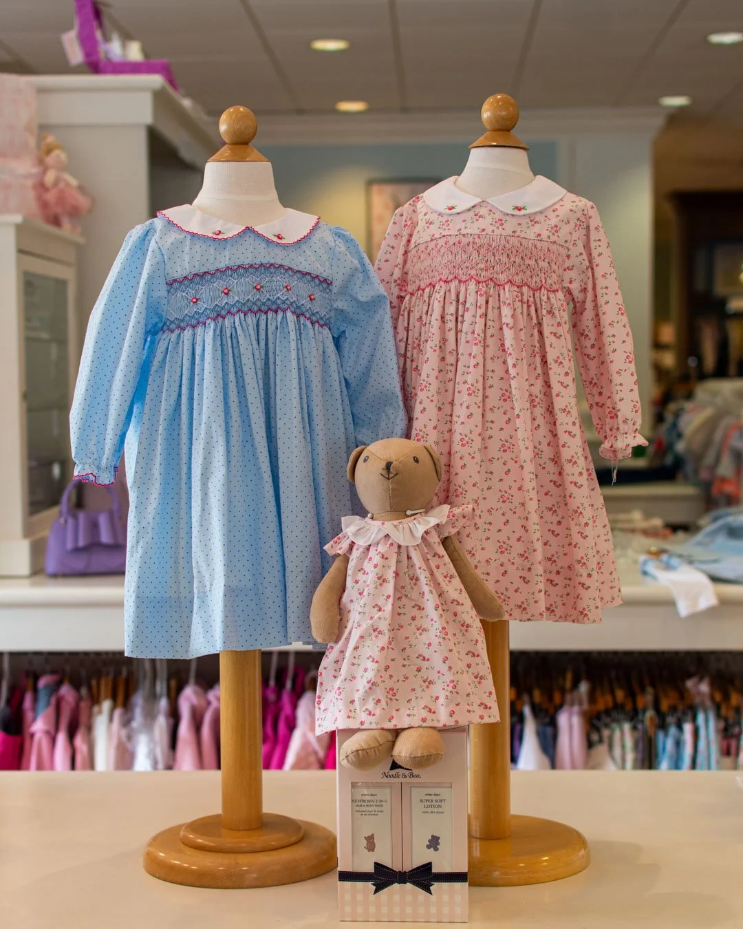 Two long-sleeve smocked dresses from Petit Ami with a matching bear! 🧸