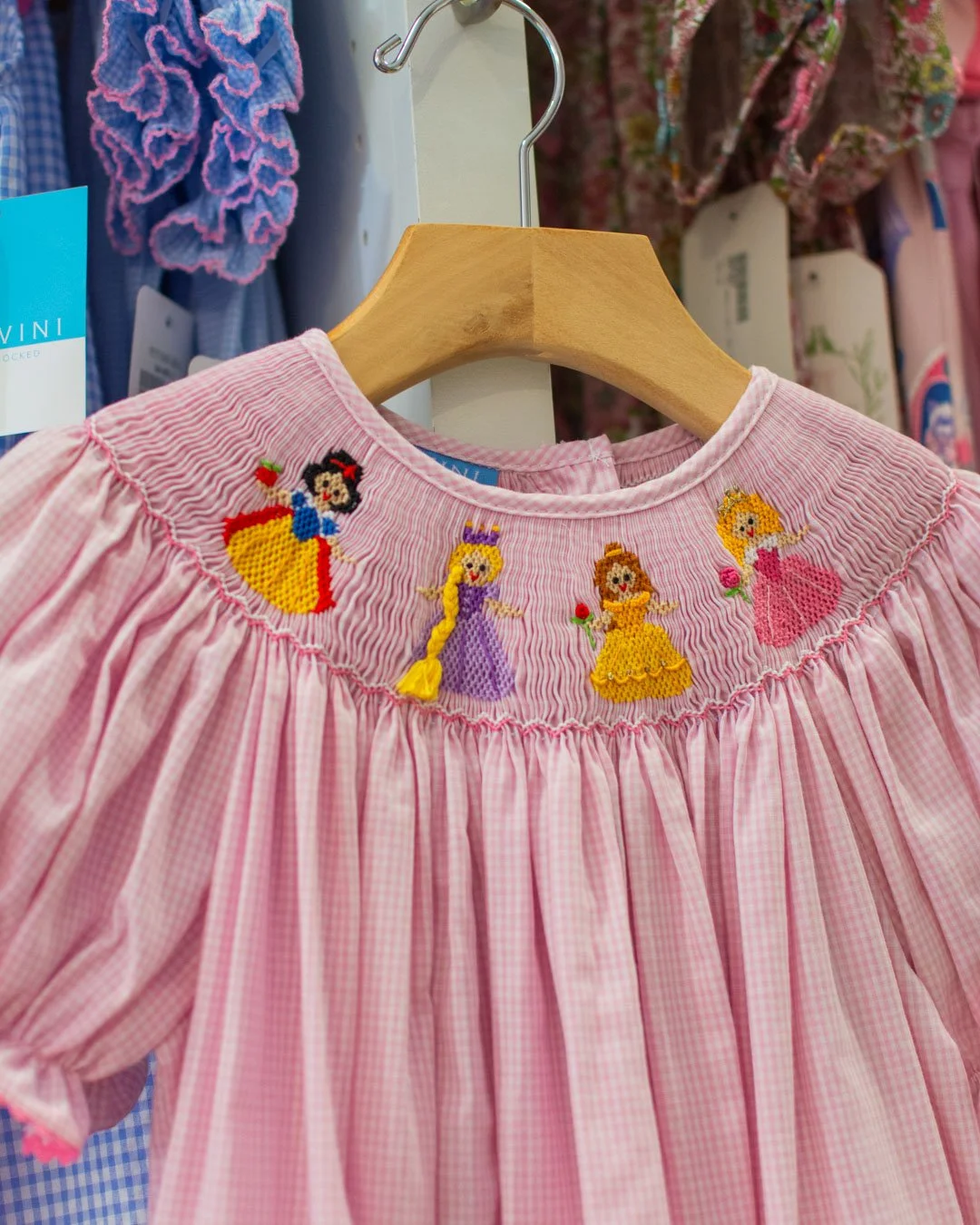 Pretty smocked princess dresses from Anavini and Velani. 👑 We love the 3d hair braid on Rapunzel.
