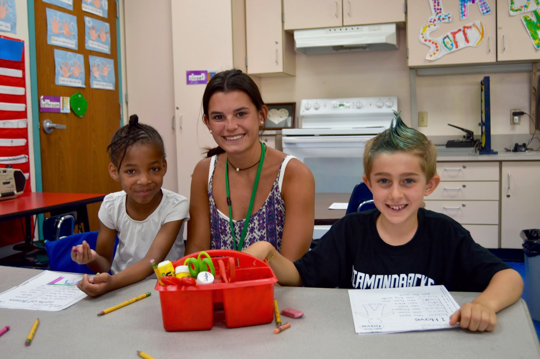 Paige Freyre with her two kindergarden students on crazy hair day at East School in New Canaan.