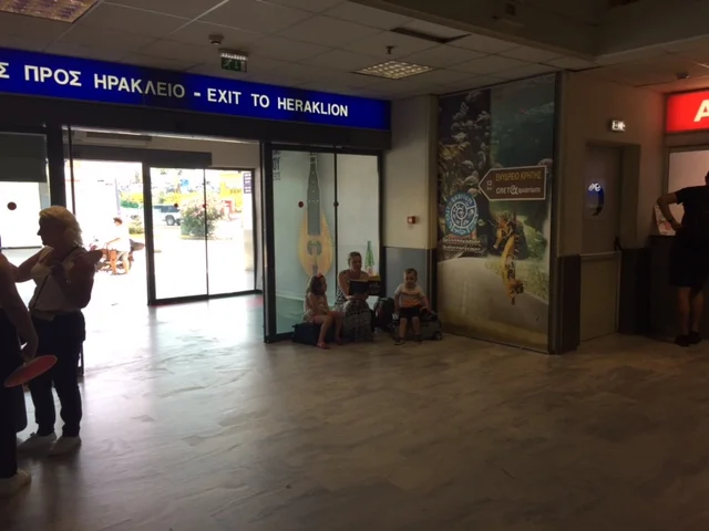 That's me in the corner of the Heraklion airport, reading the same books over and over again to try and entertain the kids while we waited for our rental car. 