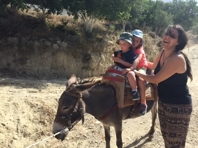 Riding Louiza, the donkey. They look petrified here, but they actually loved it. 