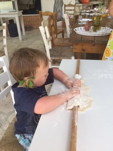 Brendan rolls out dough to make cheese pies.