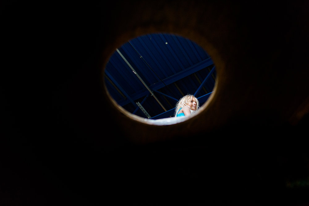 Head of girl seen through circular cutout