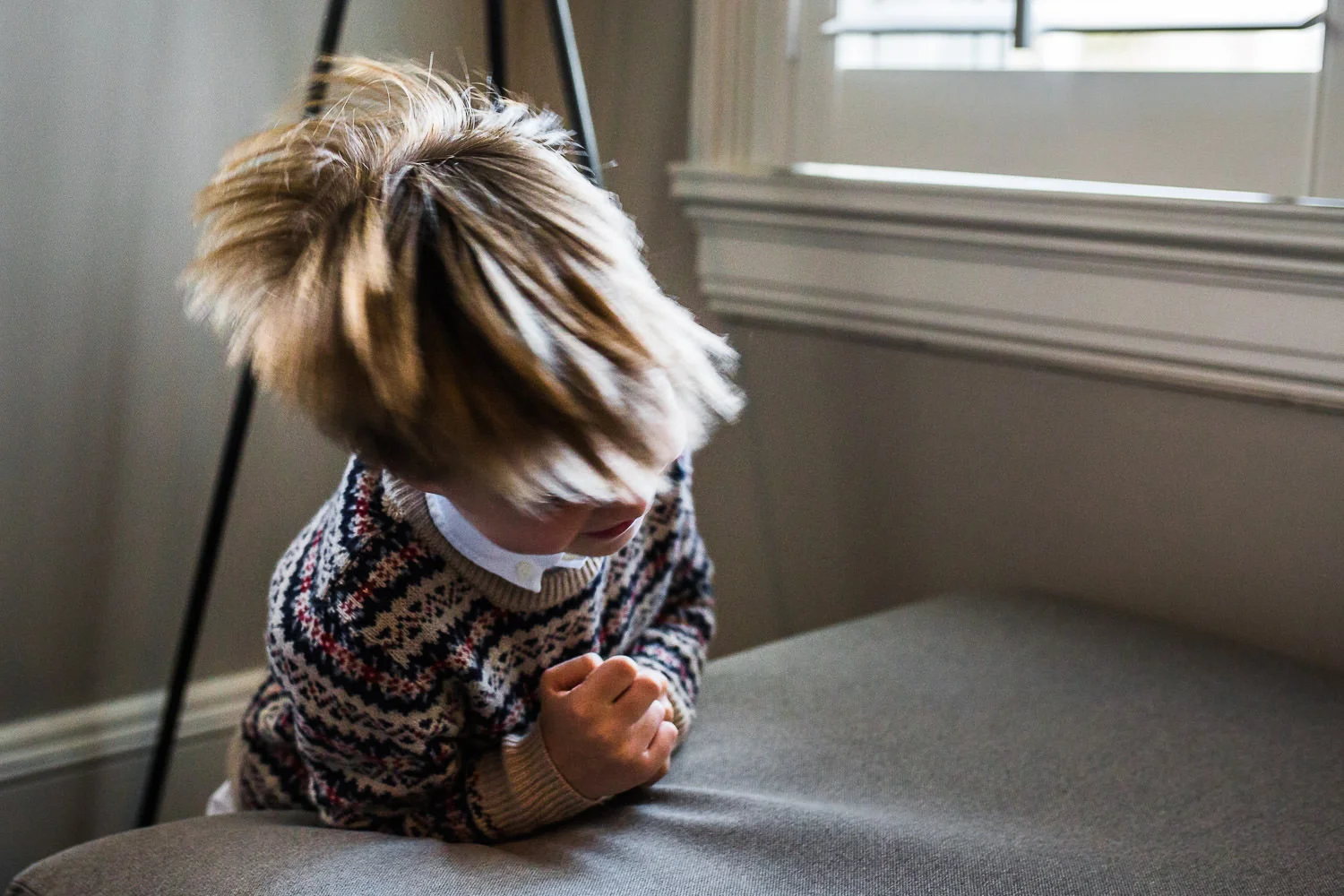 boy shaking head so hair is moving
