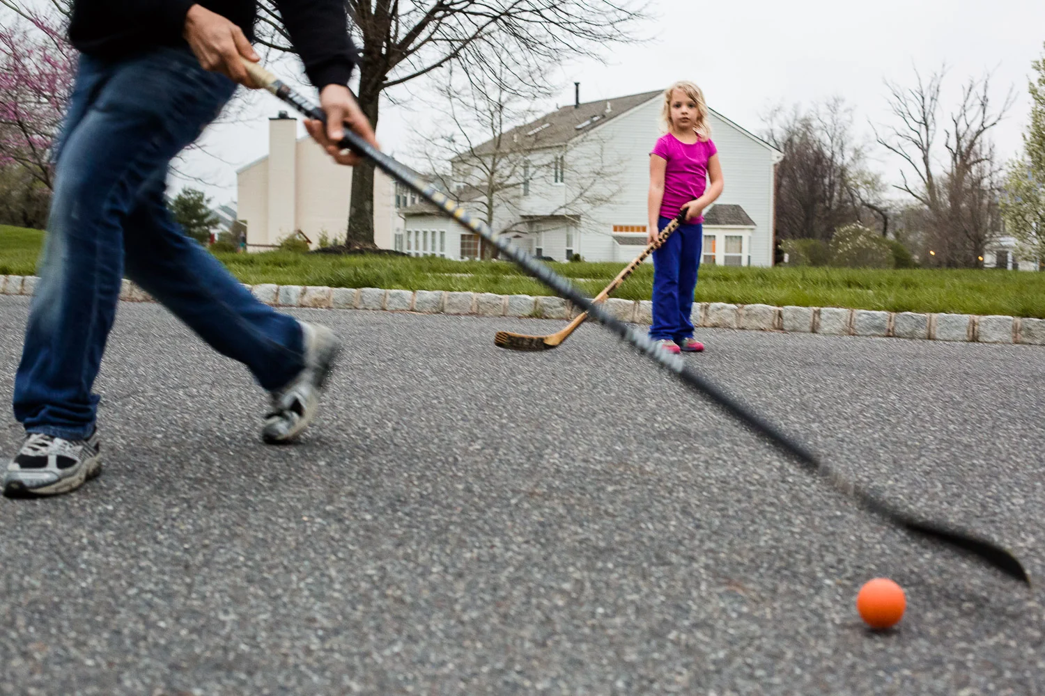 little girl playing street hockey