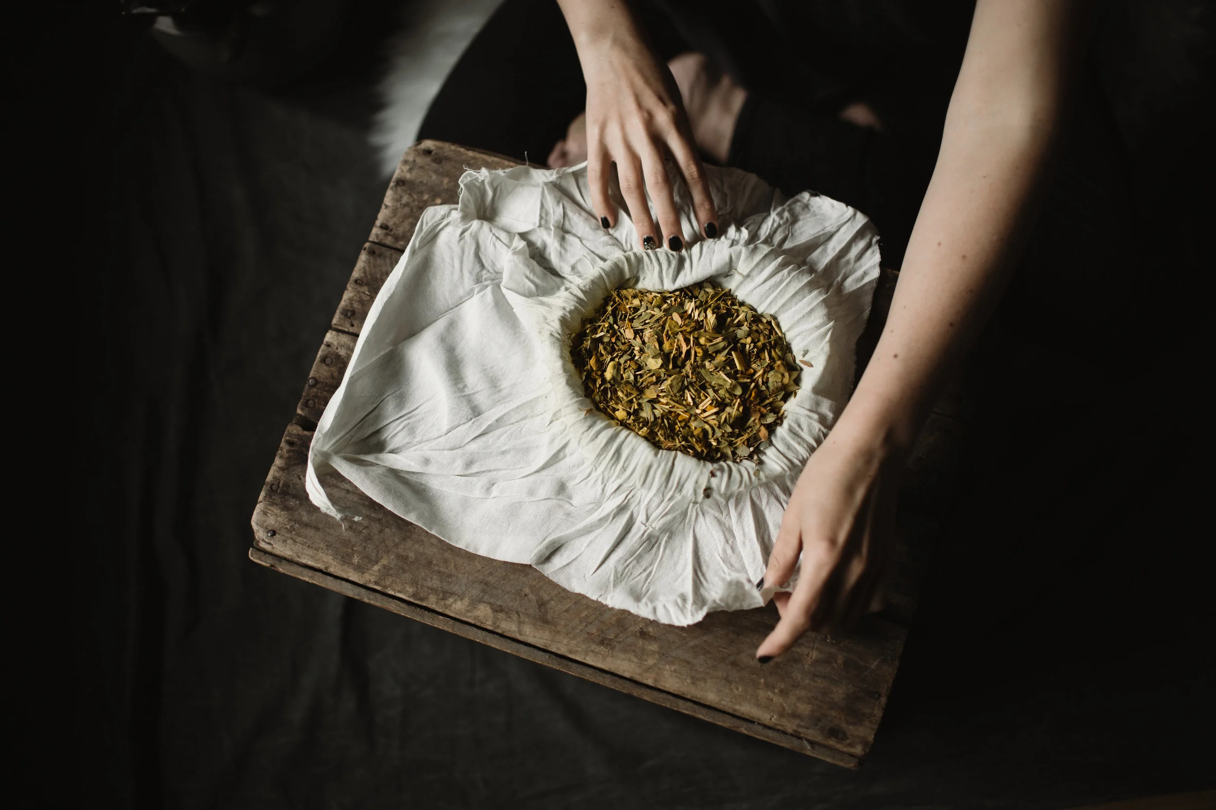 Preparing Thai herbal compress to be steamed and applied to the body