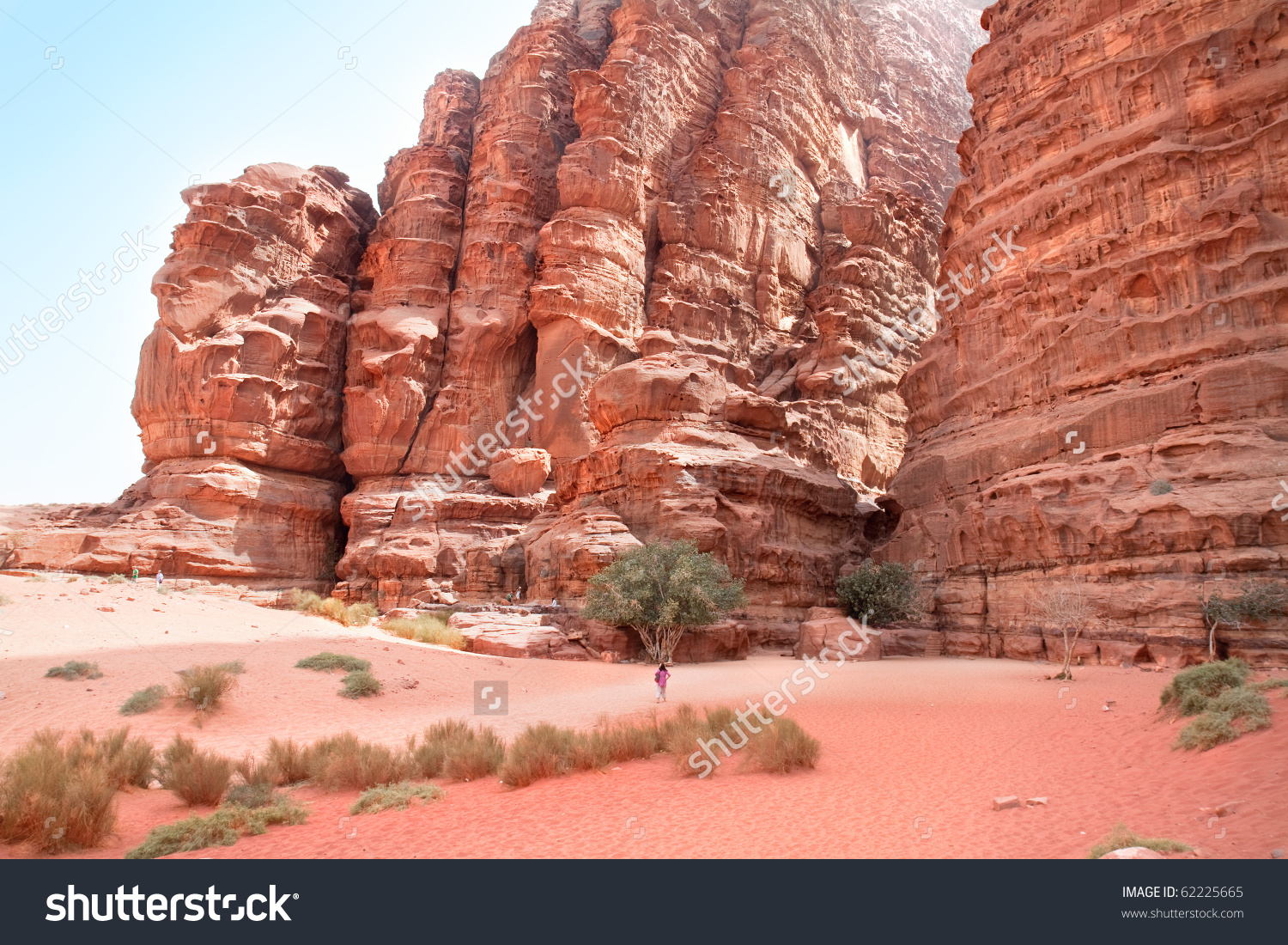 stock-photo-huge-cliff-of-khazali-canyon-in-wadi-rum-containing-many-rock-inscriptions-wadi-rum-jordan-62225665.jpg