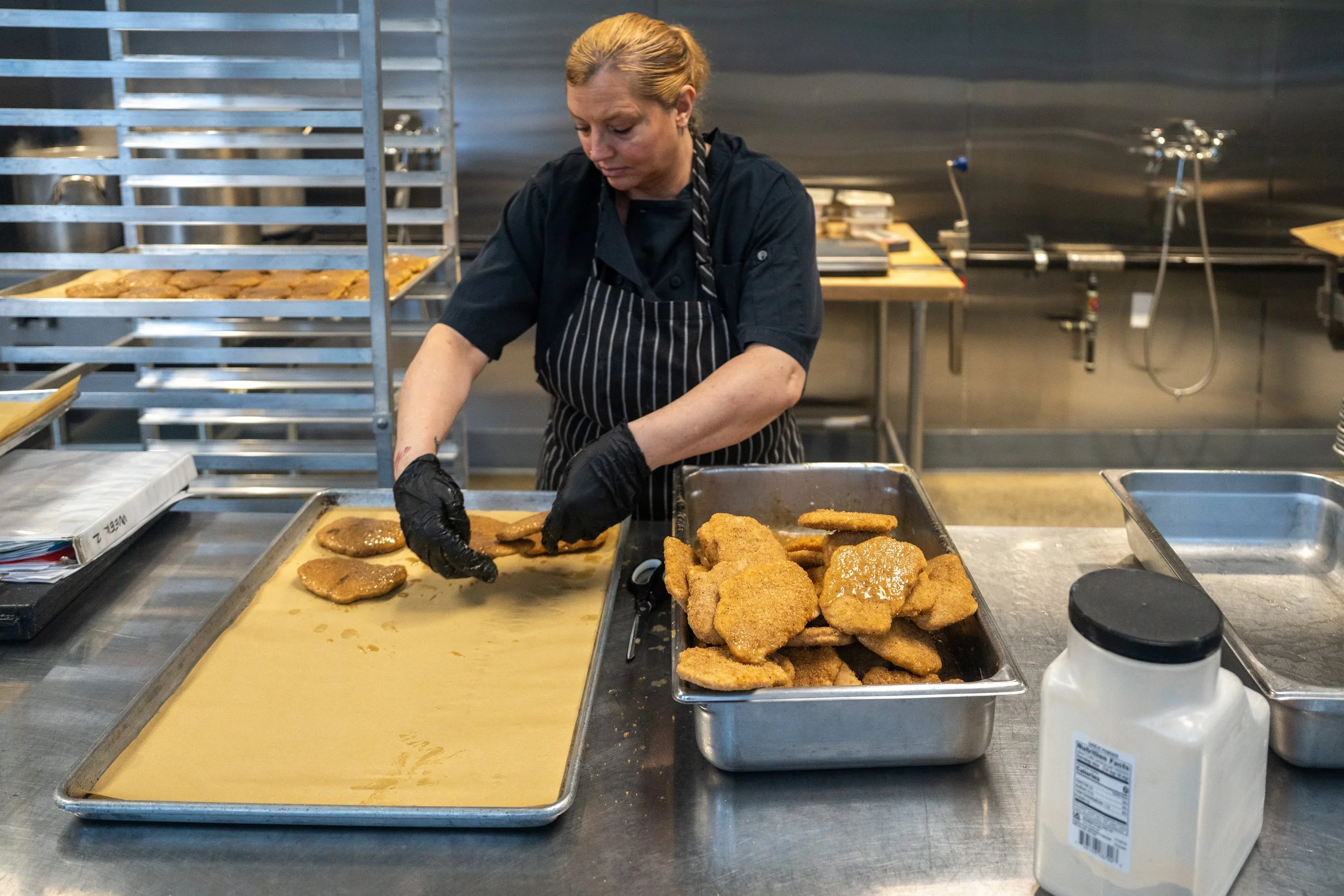 Lifelong Kitchen staff laying out food in a tray