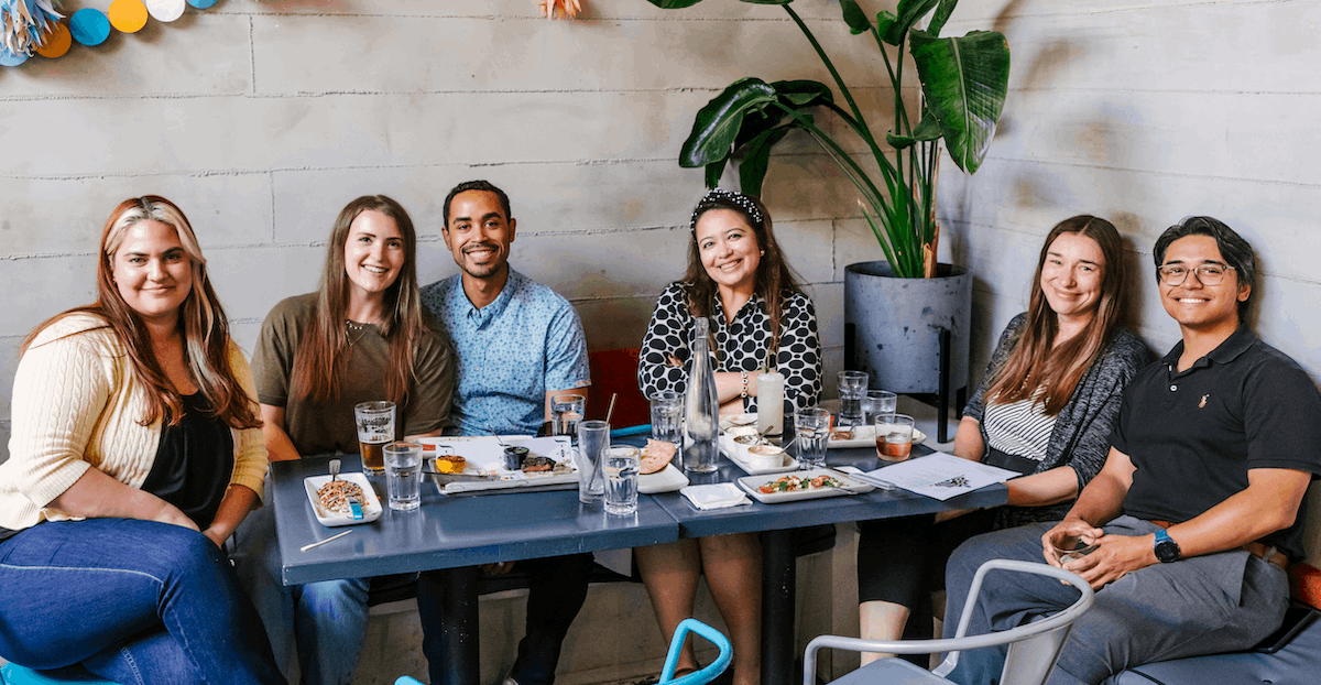 group of friends sitting at restaurant table