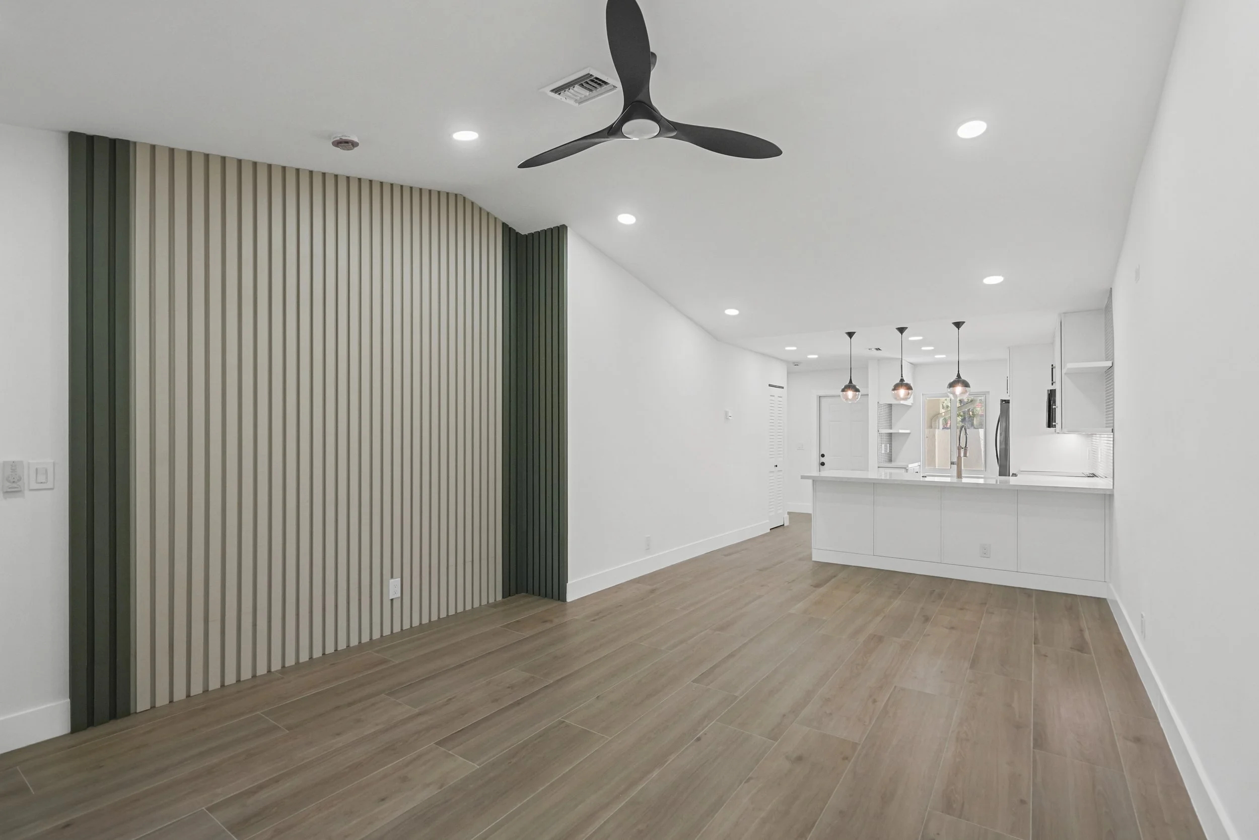 CUSTOM SLAT WALL FEATURE IN FAMILY ROOM
