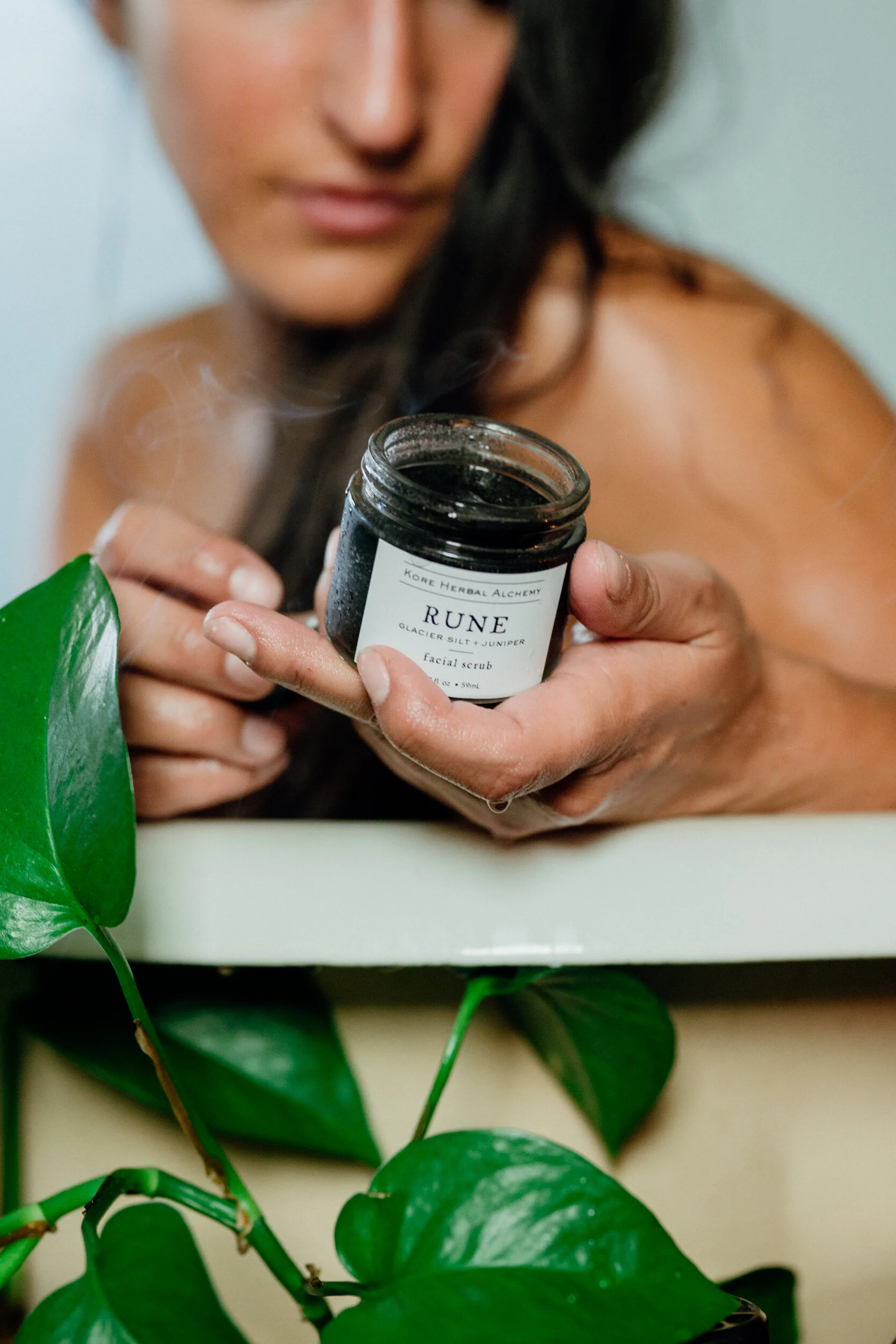 Kore Herbals Rune Glacier Silt and Juniper Scrub and Mask with woman