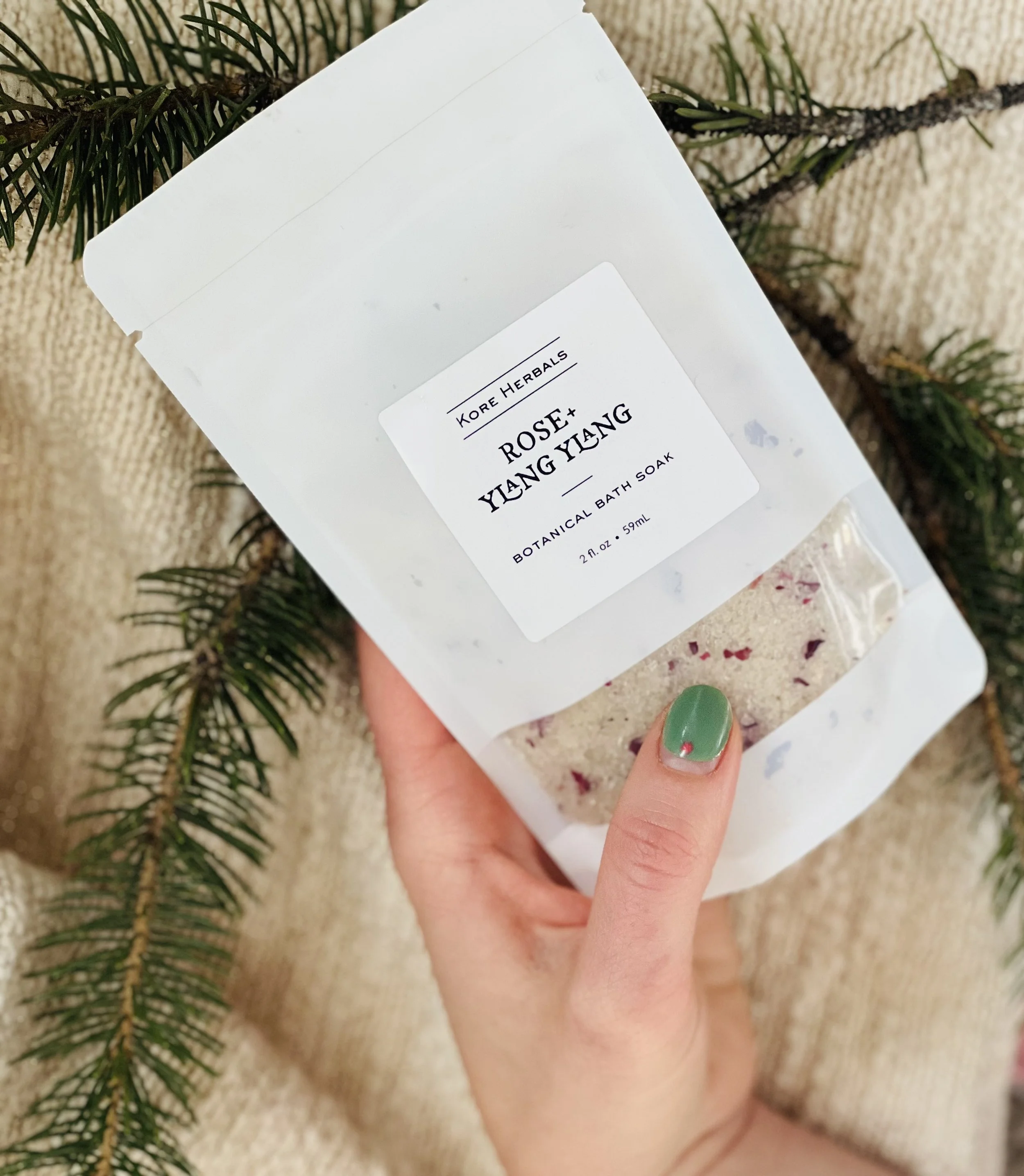 Kore Herbals Botanical Bath Salts being held by hand