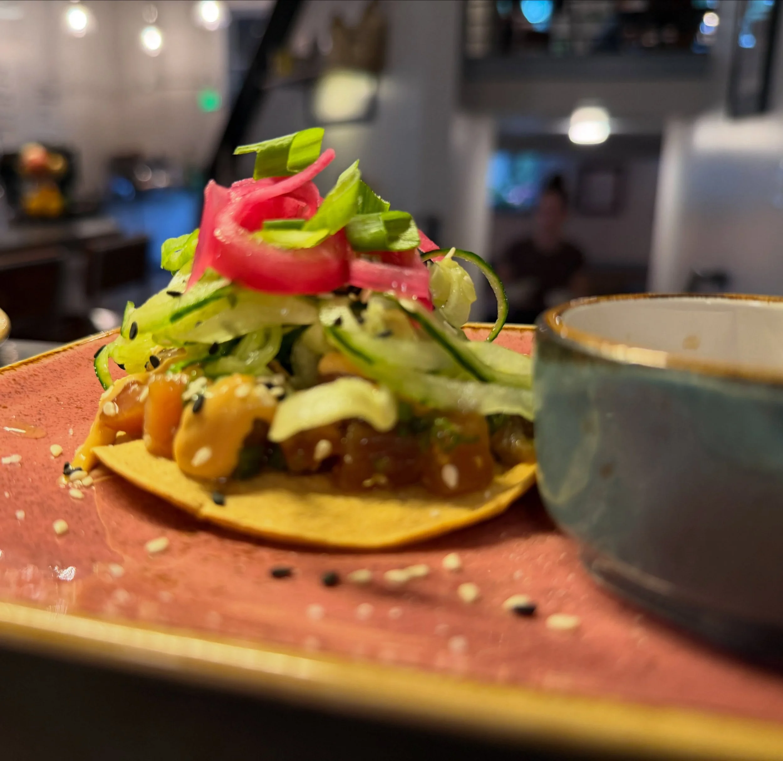 Tuna Tartare Tostada - grew up near the ocean. this one&rsquo;s for that. 🌊

diced ahi tuna with fresh ginger, chive, tamari and sesame oil &mdash; piled onto a tostada with chipotle mayo, cucumber noodles and sesame seeds.

two pieces. gone in seco