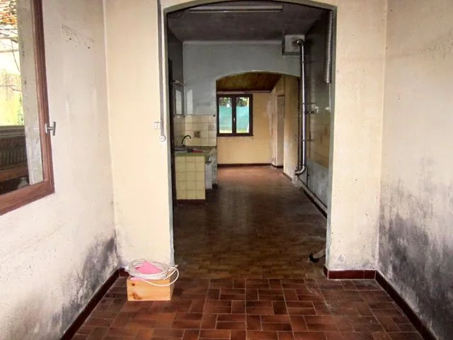 Galley kitchen facing the garden leading out to garage and laundry
