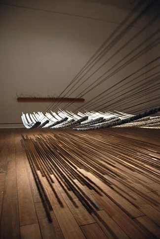 <i>Between the Petals II</i>, porcelain, piano tuning block, pins, wire, h. 40" x w. 192" x d. 60", 2010