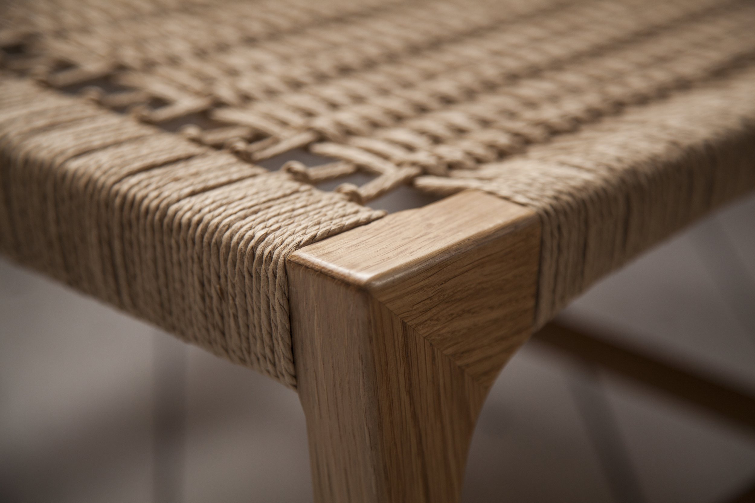 Close-up of a softened front leg corner with tightly woven seat cords.